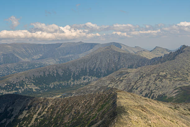 istock Panoramic view of mountain ranges. Rock ridge with various peaks for rock climbing 1294542853
