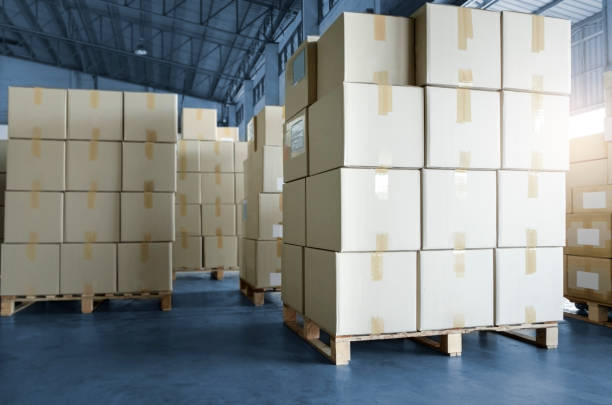 istock Stack of cardboard boxes on pallet rack in warehouse storage. Shipment. Cargo import and export. Manufacturing industry warehousing store. 1294543499