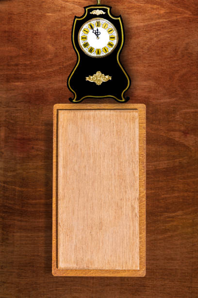 Blank nameplate for a name or title with clock on a dark wood natural background