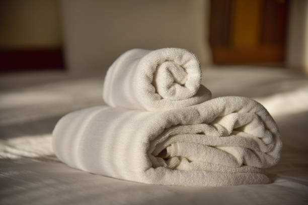 istock White towel on the bed in dark. 1294545868