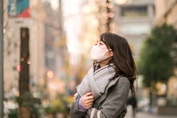 istock Woman looking at illuminated tree on street 1294546759