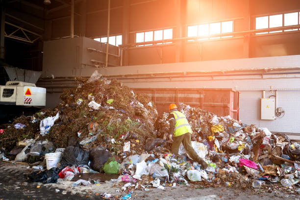 istock a worker sorts through garbage in a factory for waste recycling. 1294546903