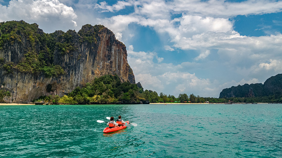 Family kayaking in sea, mother and daughter paddling in kayak on tropical sea canoe tour near islands, having fun, active vacation with children in Thailand, Krabi