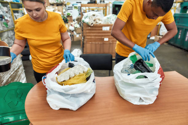 istock Young girl and man sorting litter from plastic bags 1294548846