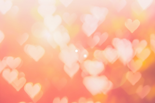 Blurred background of Valentine's day concept. Pink Valentines Day Card. Pastel color tone soft have gradient pattern. Multicolor white pink, orange and red hearts blur wallpaper in love bright sexy.