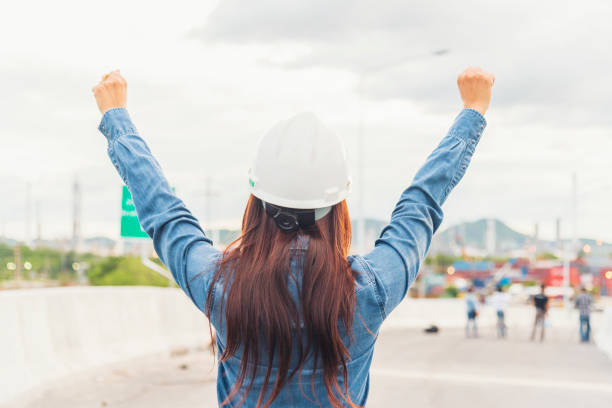 istock Woman engineer entrepreneur construction industry worker. Female engineer working refinery oil plant manufacturing. Young civil engineering construction wear hard hat safety helmet construction site. 1294552327