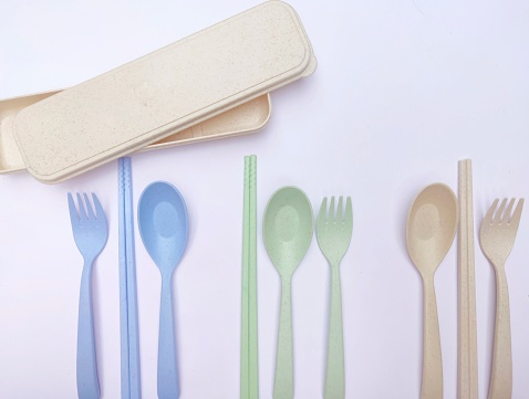 Multicolored of cutlery and box, made of wheat straw. Reusable and eco friendly
