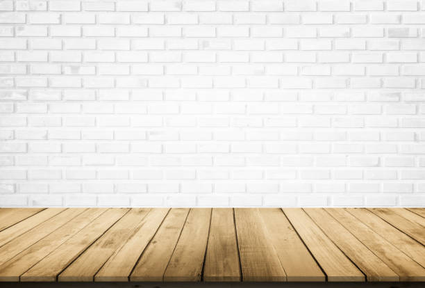 istock Empty wooden table top on white brick wall background, Design wood terrace white. Perspective for show space for your copy and branding. Can be used as product display montage. Vintage style concept. 1294553954