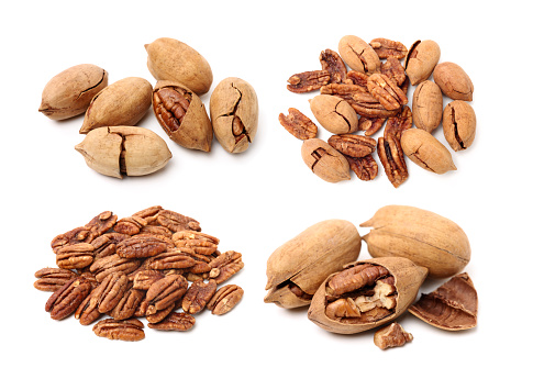 Peeled pecan nuts closeup, isolated on white background