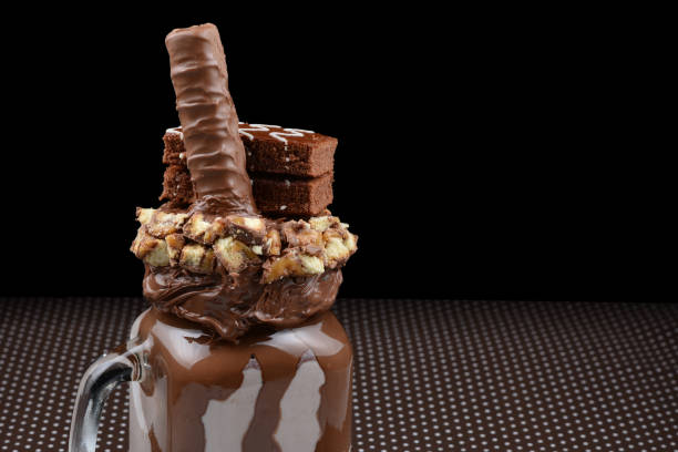istock Chocolate extreme milkshake with brownie cake, chocolate paste and sweets. Crazy freakshake food trend. Copy space 1294555204