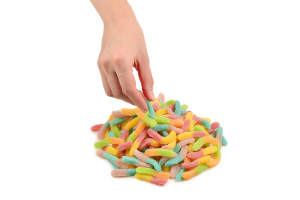 istock Female hand holding jelly sweets isolated on white background 1294555210