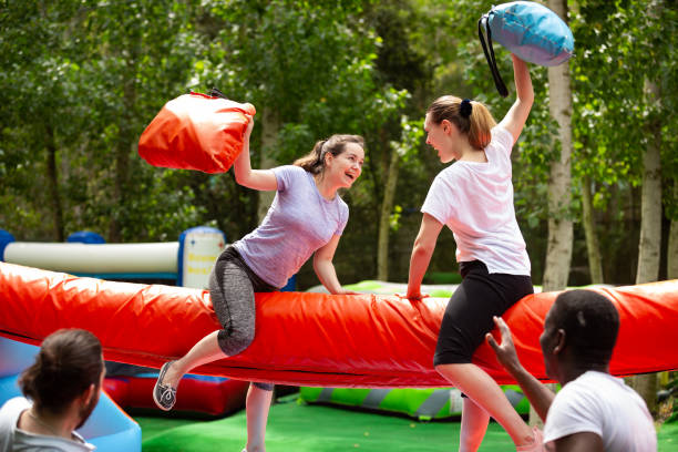 istock Pillow fight between girlfriends in an amusement park 1294555302