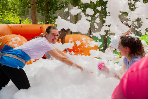 istock Friends picking up balls in inflatable pool with foam 1294555305