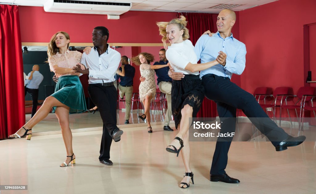 People dancing rock-and-roll in pairs Young positive people dancing rock-and-roll in pairs Dancing Stock Photo