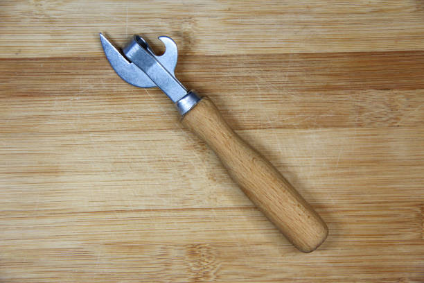 istock Can opener with wooden handle on wooden background 1294556121