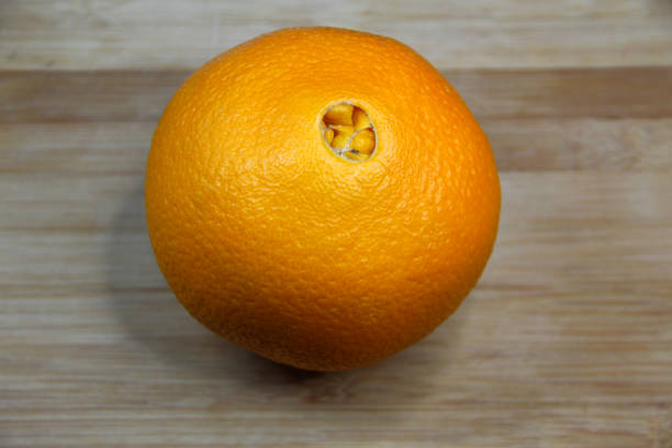 istock Big orange fruit on wooden background, close up 1294556124