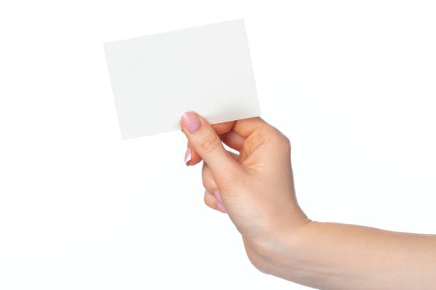 istock Woman's hand with blank white business card isolated on white 1294560507