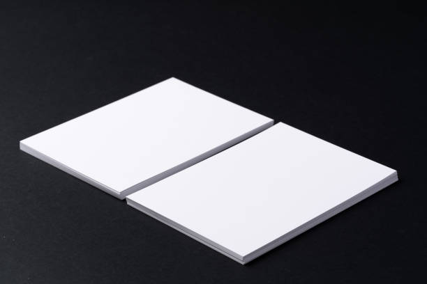 istock White blank business cards on dark black background 1294563725