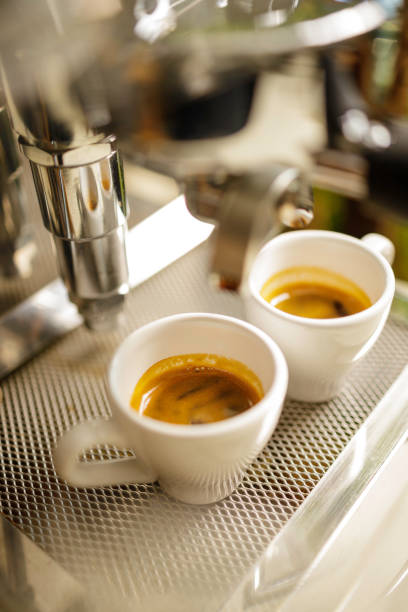 istock two cups of espresso being poured from an espresso machine 1294564809
