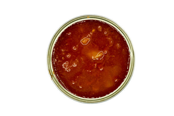 istock Tomato pieces in can isolated on white background top view 1294567304