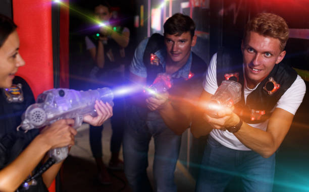 istock Man holding colored laser guns and took aim during laser tag gam 1294568664
