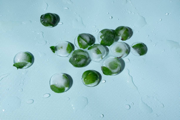 istock Mint leaves frozen in ice cubes 1294568681