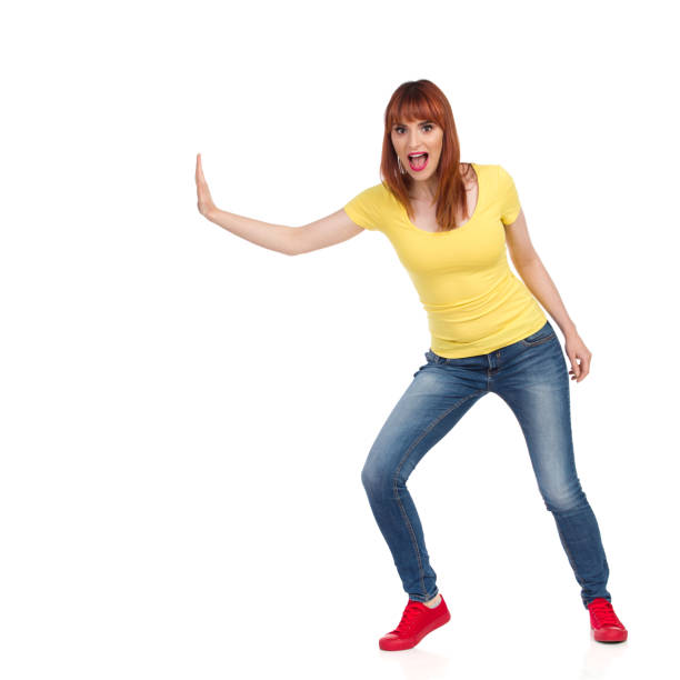 istock Excited Young Woman Pushing Something With One Hand 1294569700