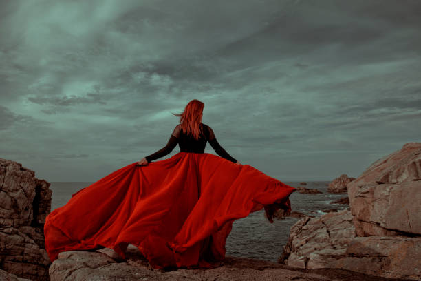 istock Redhead holding skirt looking away 1294571366
