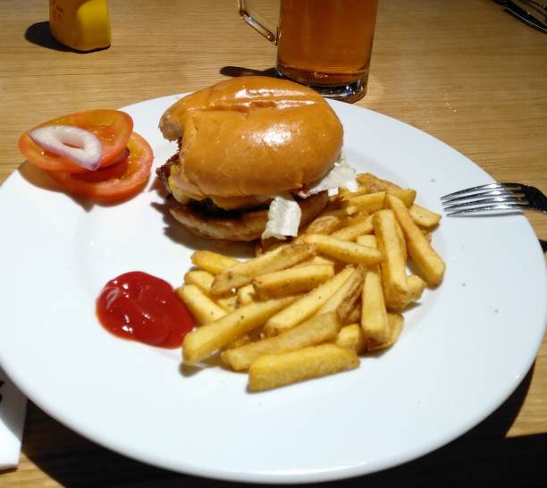 istock Burger with potatoes and a beer 1294571693