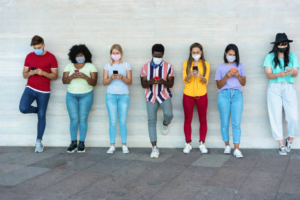istock Multiracial group of people with face mask using mobile phones - Focus on faces 1294577441