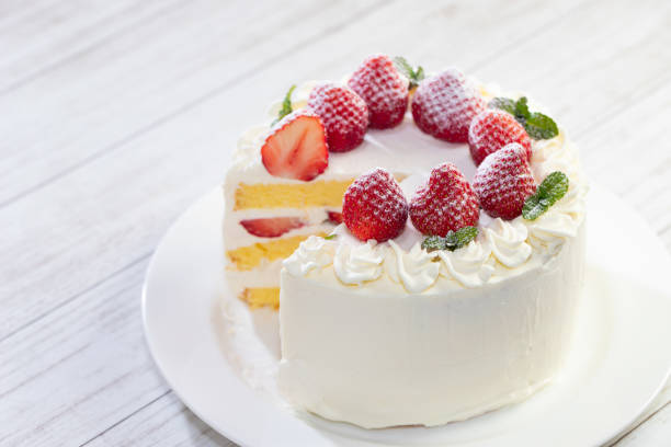 istock Strawberry and cream sponge cake on white wooden table 1294578077