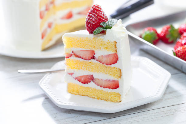 istock Strawberry and cream sponge cake on white wooden table 1294578134