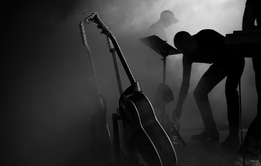 foggy stage with guitars and musicians just before the show begins - Black and white