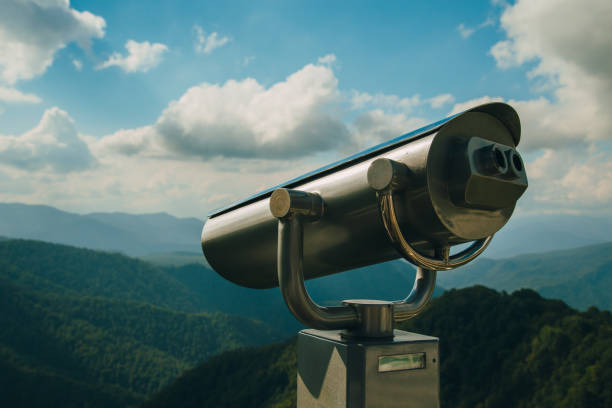 istock Binoculars with coins overlooking the Blue Mountains, Landscape with beautiful cloudy sky and mountains .. 1294579189
