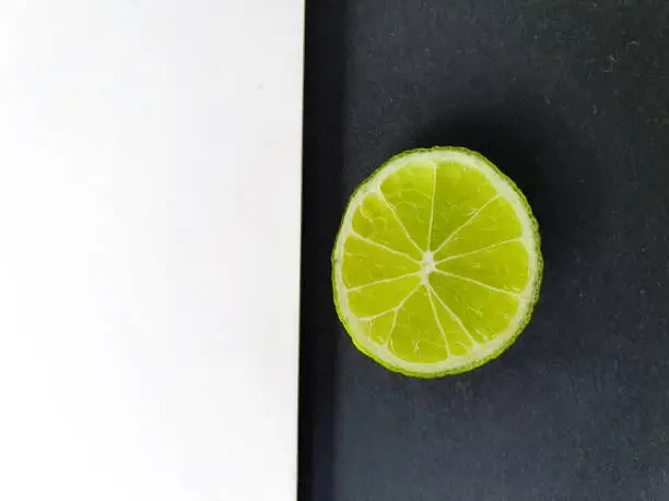 Photo of Creative layout made of lime. Flat lay.  Food concept. Lime on black background.