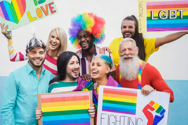 istock Gay people having fun pride parade with LGBT flags outdoors - Main focus on bottom guys faces 1294582481