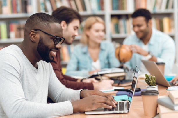 istock Group of ethnic multicultural students in library. Students are studying. 1294582523