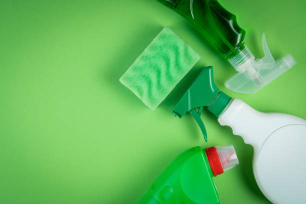 istock Cleaning supplies on green background 1294587230
