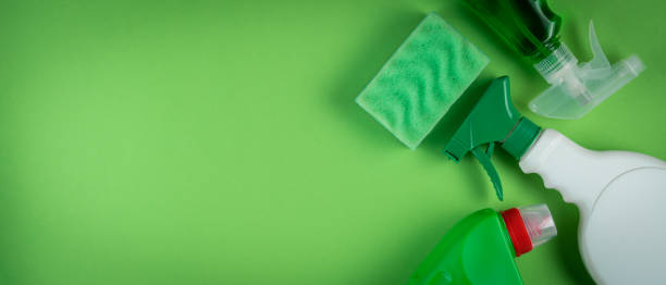 istock Cleaning supplies on green background 1294587235