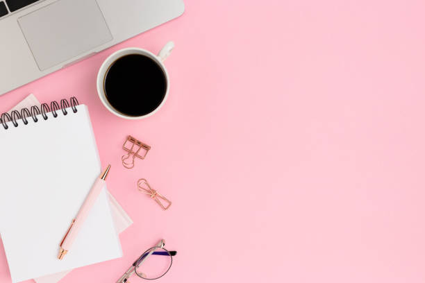 istock Workspace for e-learning with laptop and coffee on a pink background. 1294590086