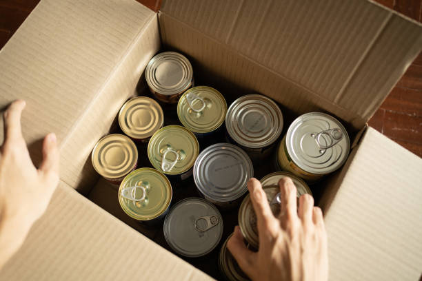 istock Storing canned foods in a cardboard box 1294592668