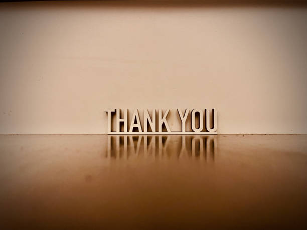 istock Thank you text on gray background 1294593642