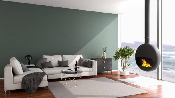 istock Modern loft style apartment with a stylish fireplace looking out to a beach through large floor-to-ceiling windows. 3d render 1294595050