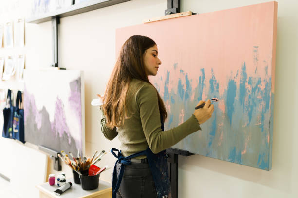 istock Young woman is creating a new artwork during a class 1294596517