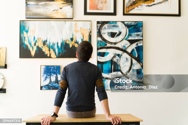 Rear View Of A Guy In His 30s Looking At An Art Exhibition Stock Photo - Download Image Now