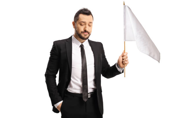 istock Disappointed businessman holding a white flag 1294601243