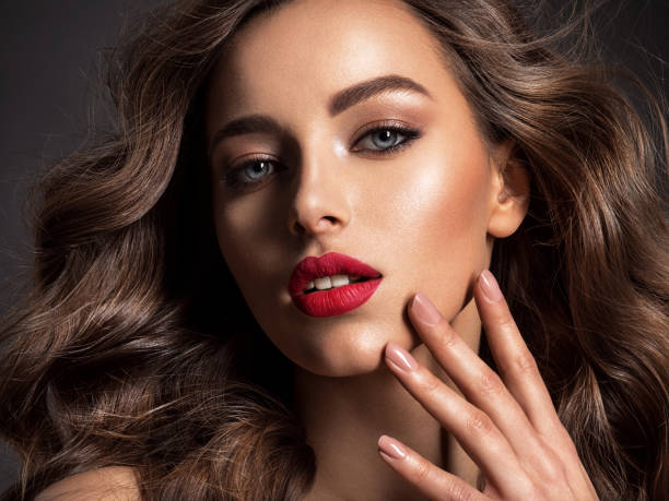 istock Beautiful face of an attractive model with red lipstick. 1294601801