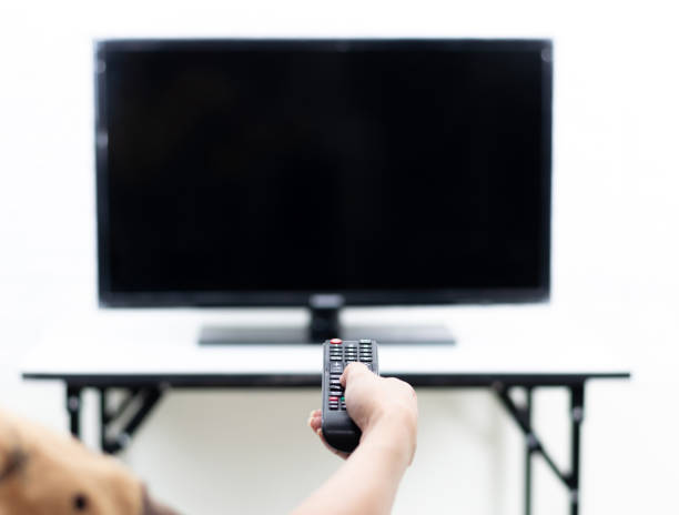 istock Hand holding the remote to turn on the TV 1294602934