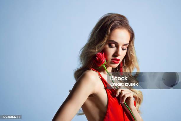 Beautiful Woman In Red Dress Holding Rose Stock Photo - Download Image Now - Falling in Love, Rose - Flower, Valentine's Day - Holiday