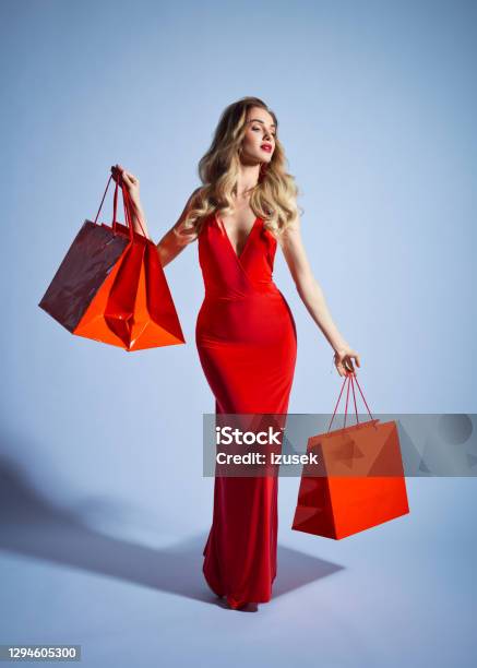 Elegant Woman In Red Dress Stock Photo - Download Image Now - Shopping Bag, Fashion Model, Evening Gown